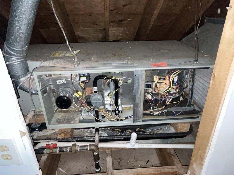 Responded to no cooling complaint on approximately 10-year-old residential air conditioning system. Upon arrival, accessed horizontal air handler unit located in attic space and performed diagnostic evaluation. Removed access panel to inspect internal components including blower motor, electrical connections, control boards, and refrigerant lines. Identified system malfunction preventing proper cooling operation. Completed necessary repairs to restore cooling functionality, verified proper airflow through ductwork, and confirmed all electrical connections were secure. Tested system operation to ensure unit was cooling effectively before departure.