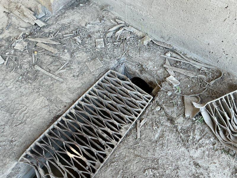 Responded to commercial kitchen drain clog during business hours. Upon arrival, inspected exterior floor drains and discovered significant debris accumulation including organic matter, leaves, and plant material obstructing the drain grates and surrounding concrete surface. Removed and cleaned heavily soiled evaporator coil component that had accumulated substantial dust and debris buildup, which was contributing to drainage issues. Cleared all visible obstructions from drain openings and grates, restoring proper water flow. Documented conditions with photos showing before state of debris accumulation on concrete drainage area and contaminated HVAC components affecting the system.