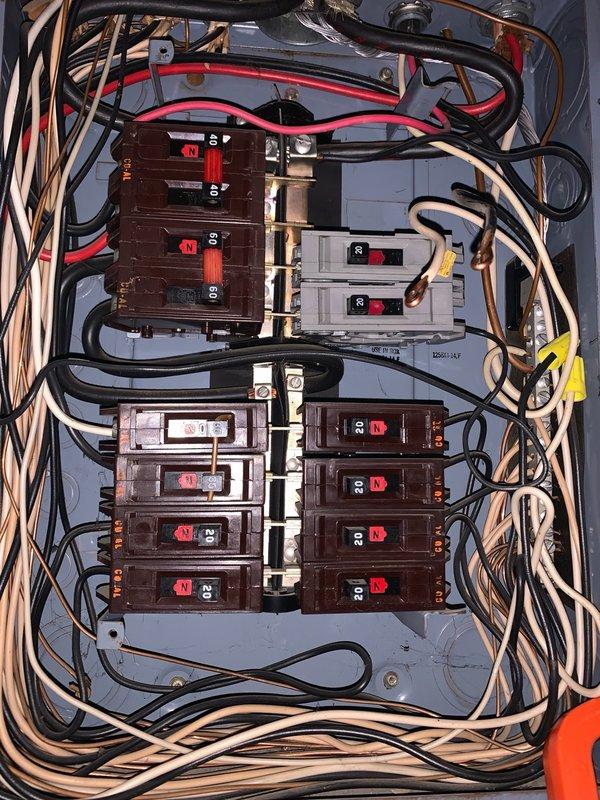 Completed follow-up inspection of electrical panel and service meter installation per HVAC department request to assess breaker condition and determine repair or replacement requirements. Documented existing panel configuration showing multiple circuit breakers in dual-column arrangement with mixed amperage ratings including 20-amp and 8-amp circuits. Verified proper wire routing throughout panel with black, red, white, yellow, and tan conductors appropriately connected to breaker terminals and central bus bar distribution system. Photographed current panel condition and exterior meter assembly with Gridstream RF digital meter, conduit connections, and associated wiring for comprehensive service records and quote preparation.