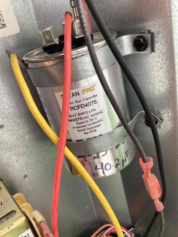 Responded to service call for thermostat displaying "open start circuit" error code 06 on residential HVAC unit located in side yard. Upon diagnostic inspection, identified failed dual-run capacitor (40+7.5 MFD, 440/370VAC) preventing compressor start circuit from closing properly. Verified capacitor failure using digital multimeter, which confirmed capacitance reading of 404.4 microfarads, significantly outside acceptable tolerance range. Replaced defective RCFD4075 motor run capacitor with new unit meeting manufacturer specifications. Reconnected all terminal wires (compressor, fan, and common) to proper capacitor terminals and secured mounting bracket. Cleared error code from thermostat, cycled system through complete startup sequence, and verified proper compressor and condenser fan operation with no fault codes present. Unit now operating within normal parameters.