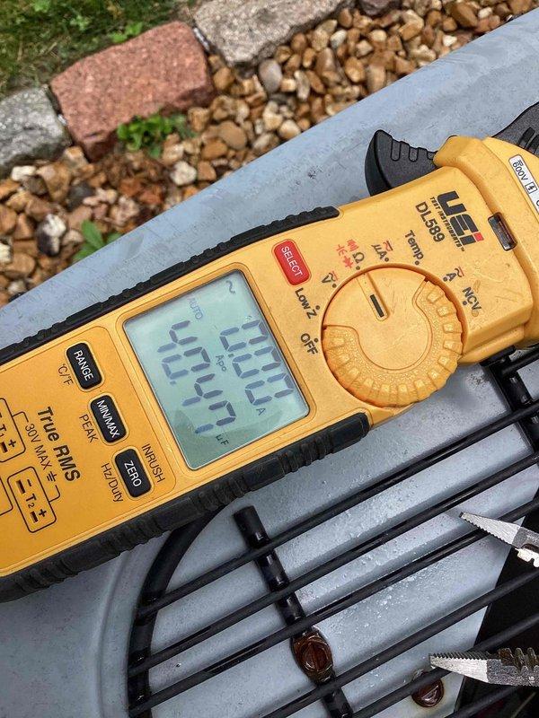Responded to service call for thermostat displaying "open start circuit" error code 06 on residential HVAC unit located in side yard. Upon diagnostic inspection, identified failed dual-run capacitor (40+7.5 MFD, 440/370VAC) preventing compressor start circuit from closing properly. Verified capacitor failure using digital multimeter, which confirmed capacitance reading of 404.4 microfarads, significantly outside acceptable tolerance range. Replaced defective RCFD4075 motor run capacitor with new unit meeting manufacturer specifications. Reconnected all terminal wires (compressor, fan, and common) to proper capacitor terminals and secured mounting bracket. Cleared error code from thermostat, cycled system through complete startup sequence, and verified proper compressor and condenser fan operation with no fault codes present. Unit now operating within normal parameters.