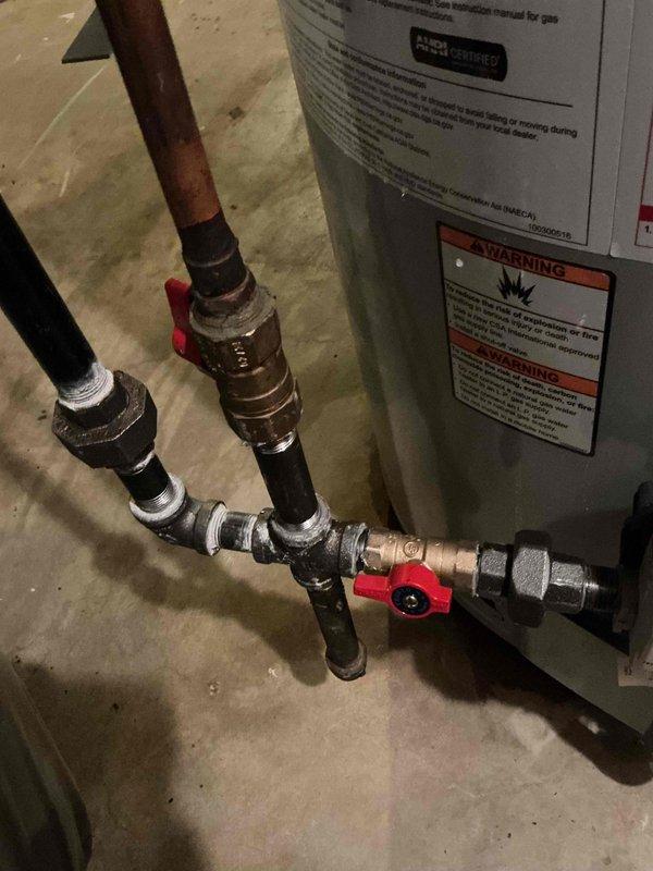 Completed installation of 40-gallon gas water heater (short model) with all required plumbing connections and safety components. Installed 3/4" pressure reducing valve to regulate incoming water pressure and protect the system from excessive pressure fluctuations. Installed 3/4" flare angle main stop valve to provide shutoff capability for maintenance and emergency situations. Connected copper supply lines with appropriate shutoff valves, including red-handled ball valves for easy water flow control on both inlet and outlet lines. Installed all necessary unions and threaded connections to facilitate future service access. Secured all gas and water connections per code requirements. Applied required plumbing identification sticker to completed installation. Work performed under permit #26PLU-11900. All connections tested and verified leak-free, unit operational and delivering hot water as designed.