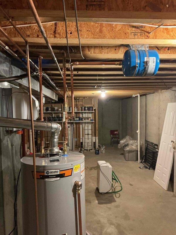 Installed a 50-gallon tall gas water heater in basement utility area, completing all copper piping connections to existing overhead plumbing system. Coordinated afternoon arrival for equipment pickup and verified City of Kirkwood permit requirements, which did not require plumbing ID sticker for this installation. All connections tested and system operational upon completion.