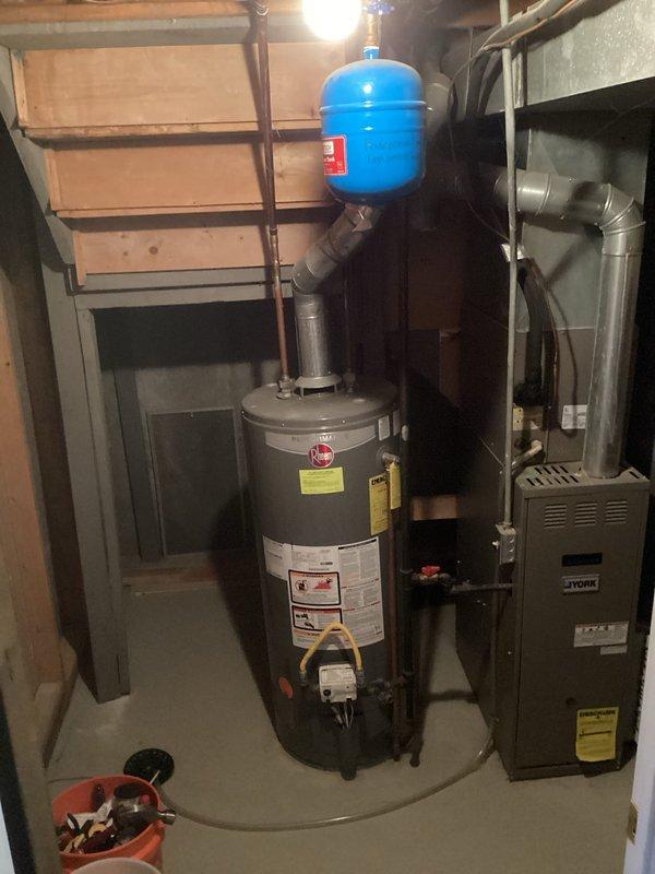 Completed full installation of 50-gallon gas tall water heater in basement to replace non-functioning unit that was no longer producing hot water. Installation included proper venting, gas line connections, water supply piping, thermal expansion tank mounting, and all required safety components per manufacturer specifications. Applied required plumbing identification sticker and ensured all work complied with permit requirements for final inspection.