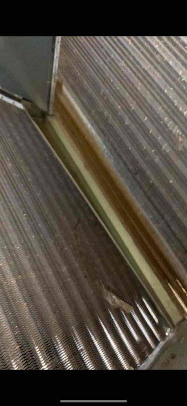 Completed preventive maintenance tune-up on outdoor condensing unit located at side of house. Inspection revealed corrosion and staining on evaporator coil fins, documented with photos. All system components checked, unit operating within normal parameters upon completion of service.