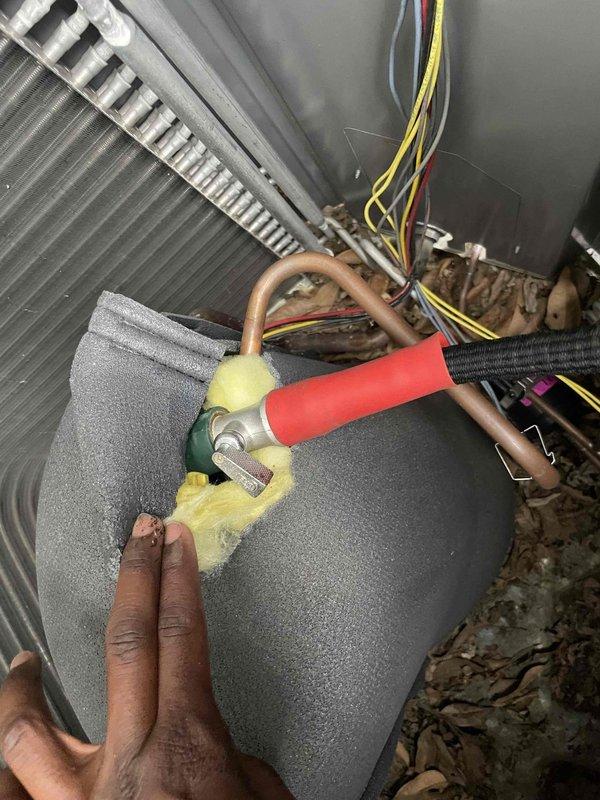 Responded to no cooling complaint on Unit 10 located at rear of property. Upon arrival, found outdoor condenser unit with heavily soiled coil panel and deteriorated base components with significant debris accumulation. Performed diagnostic evaluation of refrigerant system, accessing internal components and copper refrigerant lines for pressure and temperature analysis. Conducted hands-on inspection of heat exchanger coil, insulated refrigerant piping, and electrical connections to identify root cause of cooling failure. Work included proper handling of insulation materials during refrigerant line assessment and system component examination to restore cooling operation.