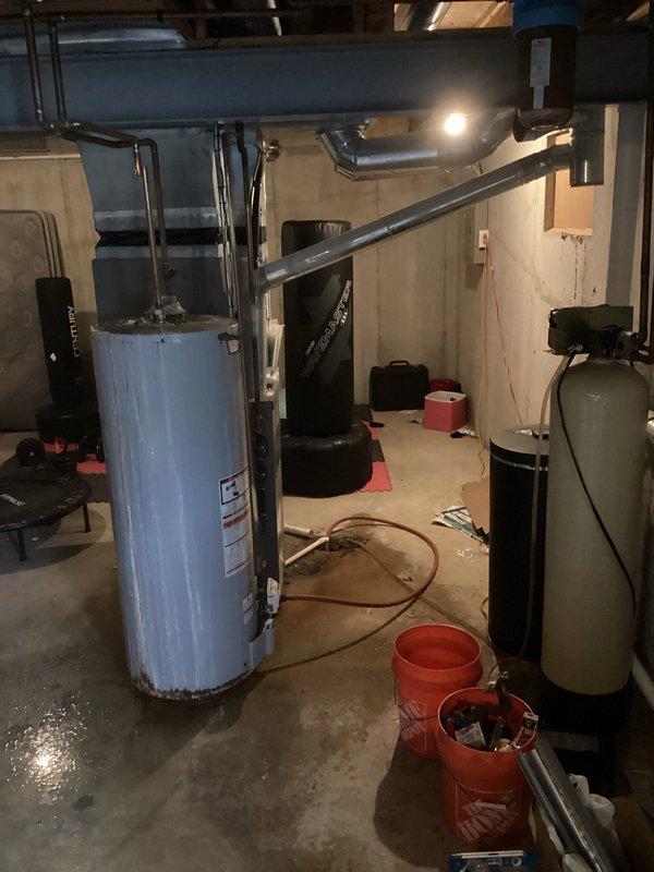 Installed a new Sterling 50-gallon tall gas water heater in basement utility area. Connected all supply and discharge piping, installed temperature and pressure relief valve with proper drainage, and established gas line connections to manufacturer specifications. Verified all connections for proper operation and code compliance per Lincoln County permit requirements.