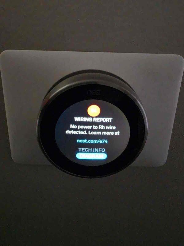 Responded to no cooling call on 1-year-old AC system with Nest thermostat displaying "No power to Rh wire" error. Upon arrival, verified 24V power supply at air handler was functioning properly and all low-voltage wiring connections were secure at both the thermostat and equipment. Inspected condensate drain line and found primary drain clogged, which had triggered the float switch safety shutoff, interrupting power to the Rh terminal. Cleared blockage from condensate line using wet/dry vacuum, flushed drain with water to confirm proper flow, and reset float switch. Restored power to thermostat, verified proper 24V at Rh terminal, and confirmed system returned to normal operation with compressor and air handler cycling correctly.