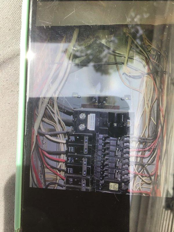 Responded to no cooling complaint on over 10-year-old Lennox system located in side yard. Customer reported system blowing warm air. Upon arrival, inspected outdoor condensing unit and indoor furnace equipment. Evaluated electrical connections at breaker panel and verified proper power supply to HVAC system. Advised customer to turn unit off and leave fan on to prevent further issues. Documented equipment condition and electrical panel configuration with photos for service records.