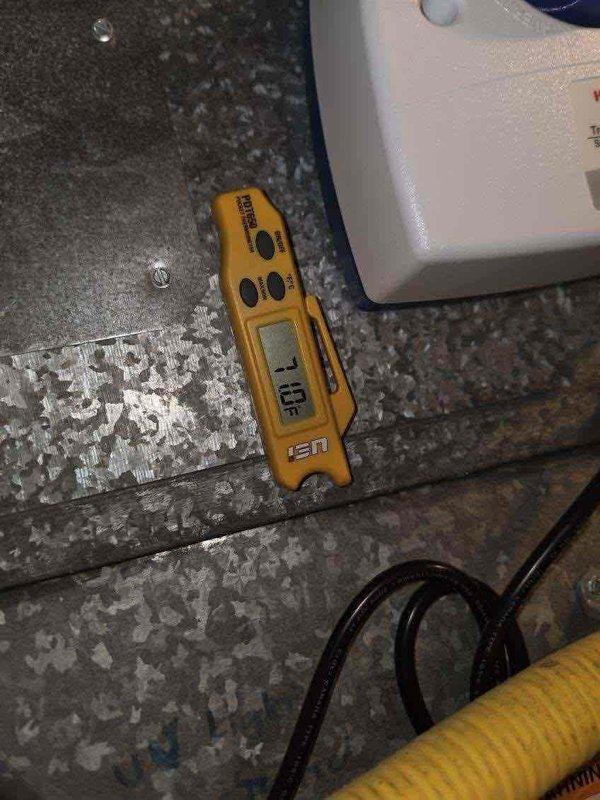 Responded to no cooling complaint on second floor for 10+ year old unit located at side of house. Upon arrival, performed diagnostic testing using pressure gauges and digital multimeter to assess system performance. Pressure readings indicated low refrigerant levels in the system. Inspected condenser coils, which showed dust accumulation and signs of age-related wear. Tested electrical components and verified proper voltage at the unit. Documented equipment condition with photos showing gauge readings and testing equipment placement on ductwork near air handler assembly.