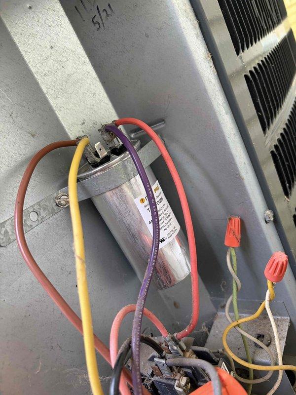 Responded to no cooling complaint on 10+ year old residential air conditioning unit located at side of house. Upon arrival, connected digital manifold gauges to service ports and evaluated system pressures and temperatures. Diagnostics revealed failed dual run capacitor preventing compressor and condenser fan motor from operating properly. Removed defective capacitor from electrical panel, installed new OEM-spec replacement capacitor, and secured all electrical connections with proper wire nuts. Verified correct microfarad ratings for both compressor and fan motor circuits. Started system and confirmed compressor and outdoor fan motor engaged properly. Monitored operating pressures and temperatures to ensure system returned to normal cooling operation with no further issues detected.