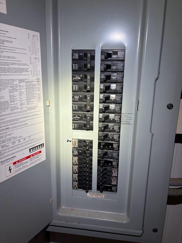 Performed comprehensive whole home electrical inspection at residential property. Conducted thorough evaluation of main electrical panel located in basement, documenting circuit breaker configuration, panel condition, and labeling system. Inspected exterior electrical service entrance including meter enclosure, weatherhead, and conduit installation mounted on brick exterior wall. All components photographed and assessed for code compliance, proper installation, and safety concerns. Panel interior showed clean condition with organized breaker layout and proper documentation affixed to door. Exterior service equipment evaluated for secure mounting, proper grounding, and weatherproofing integrity.