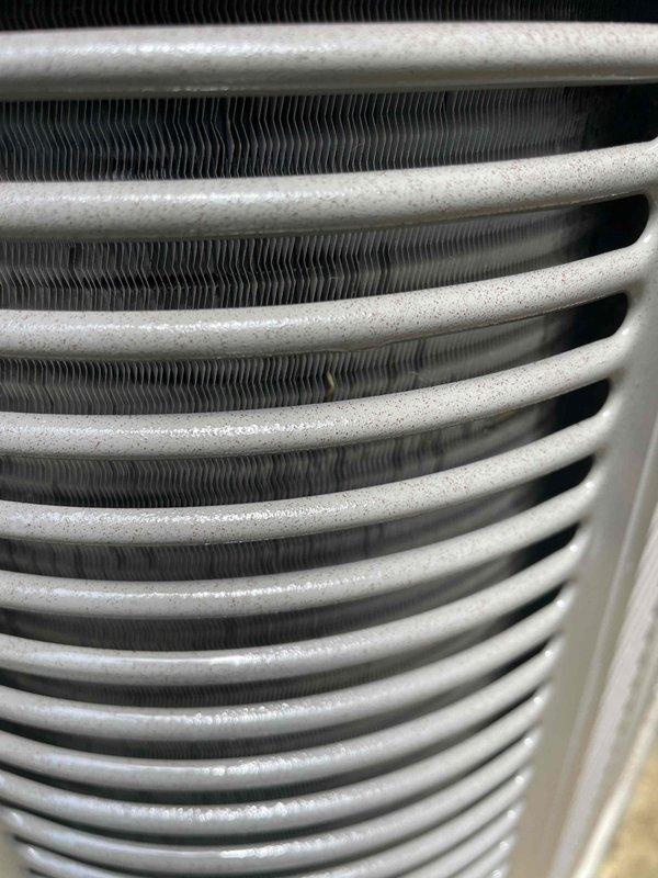 Completed comprehensive cooling system tune-up on a residential air conditioning unit over 10 years old located in side yard. Performed thorough inspection of condenser coil assembly, confirming clean heat exchanger surfaces with proper fin alignment and no debris obstruction. Inspected blower motor assembly within air handler, verified electrical connections and motor operation, and documented system components through photographic documentation for service records.
