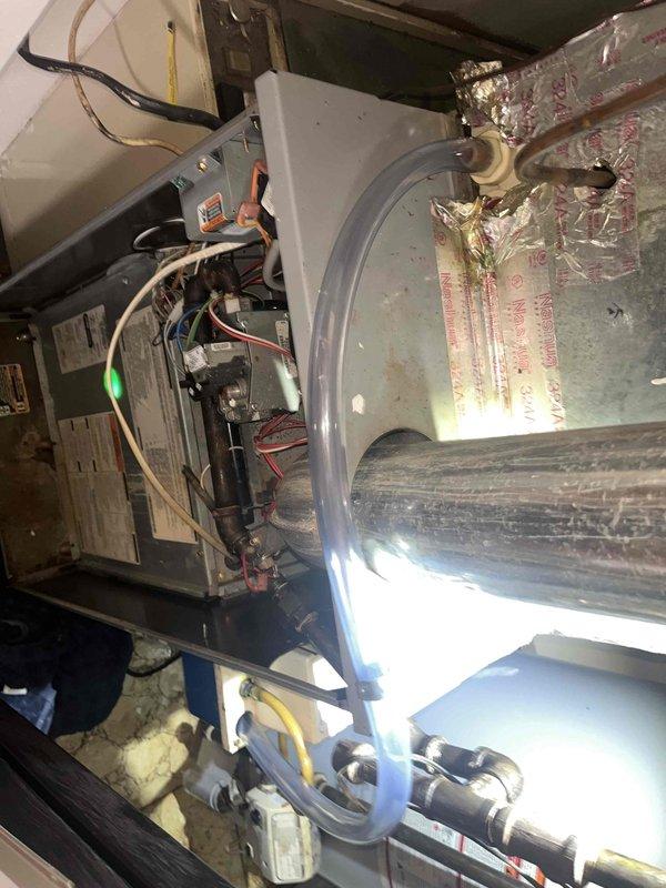 Responded to reported HVAC system leak on a unit under 10 years old. Upon inspection, accessed the furnace cabinet and examined internal components including the blower assembly, control board, and associated ductwork. Identified the source of the leak related to the humidifier system mounted on the unit. Inspected all water supply lines, drain connections, and humidifier pad assembly for signs of moisture infiltration. Performed necessary repairs to eliminate the leak, verified proper drainage, and tested the system for proper operation. Documented the internal condition of the equipment with photos showing the blower housing, control wiring, humidifier installation, and connection points to ensure all components were functioning correctly and no further water intrusion was present.