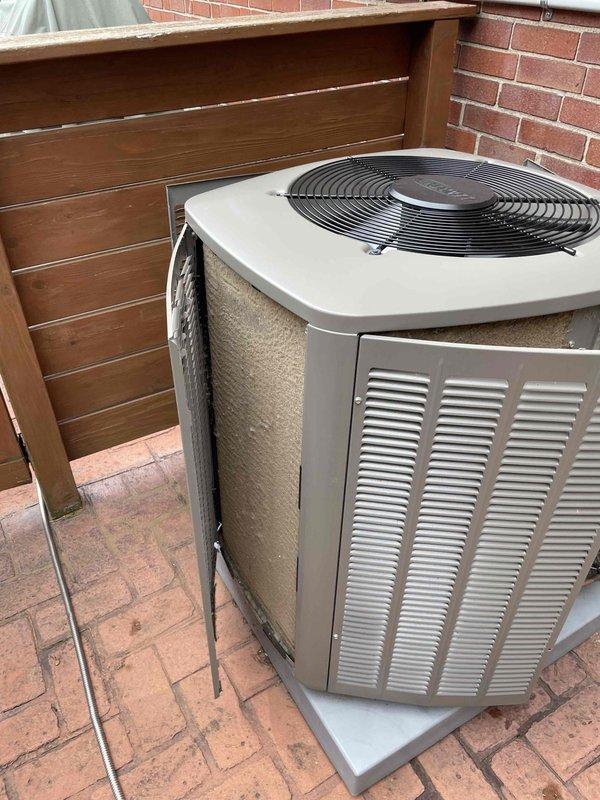Completed preventative maintenance tune-up on two Lennox air conditioning condenser units located on exterior brick paver patio area. Both units are approximately 10 years old and positioned against red brick wall with wooden privacy fence backdrop. Performed comprehensive seasonal cooling system inspection including refrigerant level verification, electrical component testing, condenser coil cleaning, fan motor operation check, and thermostat calibration on both systems. All equipment operating within manufacturer specifications with no deficiencies noted at time of service.