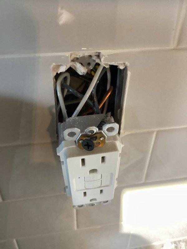 Completed comprehensive whole home electrical inspection. Inspected multiple outlets throughout the residence, including receptacles in drywall and tiled areas. Identified loose outlet installations requiring securing to junction boxes and verified wire connections including hot, neutral, and ground conductors. Documented findings with photos showing exposed wiring and improperly mounted receptacles for future repair recommendations.