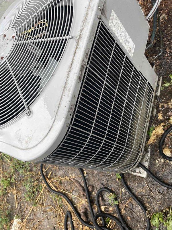 Completed comprehensive tune-up service on a 10-year-old residential air conditioning system located in backyard under Home Depot promotional program (work order F58126438). Performed standard maintenance procedures including inspection of blower motor assembly, electrical connections, and condenser unit; verified proper operation of all components; and documented equipment condition with service photographs showing accumulation of dust and normal wear consistent with unit age.