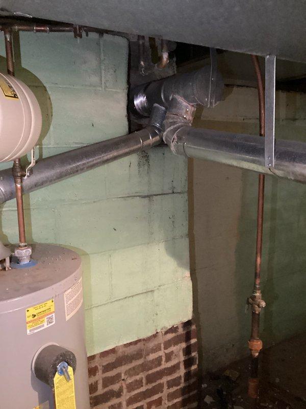 Responded to service call for HVAC system and water heater assessment following reported flood damage. Performed visual inspection of outdoor condenser unit and basement mechanical systems to evaluate operational status and extent of water damage. Documented current condition of equipment including condenser unit, ductwork, water heater, and associated plumbing infrastructure to confirm system functionality concerns.