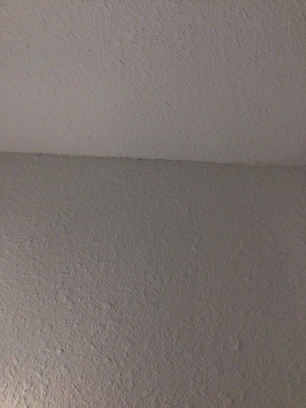 Responded to no cooling call with reported water leak from third-floor AC unit into bathroom below. Upon arrival, located 10+ year old air handler in crawlspace and identified condensate drain line obstruction causing overflow and water damage to ceiling. Cleared blockage from drain line, tested drainage flow, and verified unit operating properly with no further leakage.