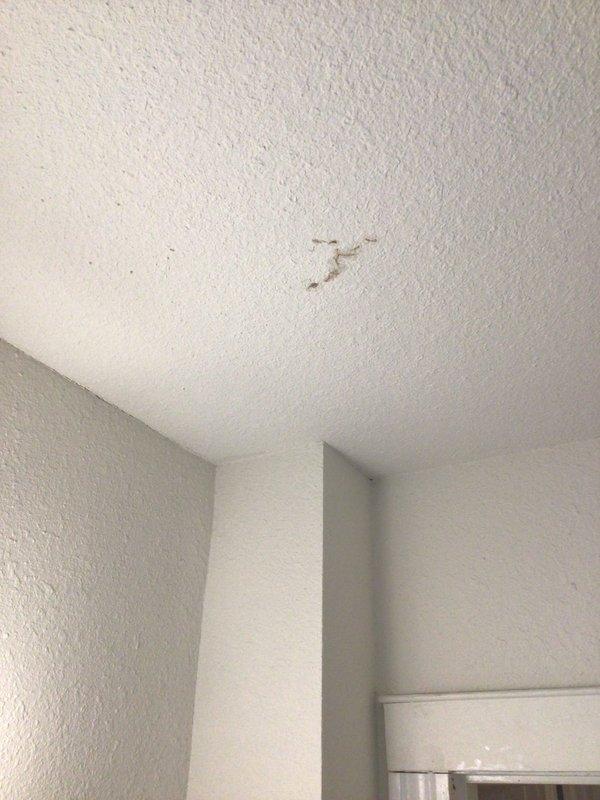 Responded to no cooling call with reported water leak from third-floor AC unit into bathroom below. Upon arrival, located 10+ year old air handler in crawlspace and identified condensate drain line obstruction causing overflow and water damage to ceiling. Cleared blockage from drain line, tested drainage flow, and verified unit operating properly with no further leakage.