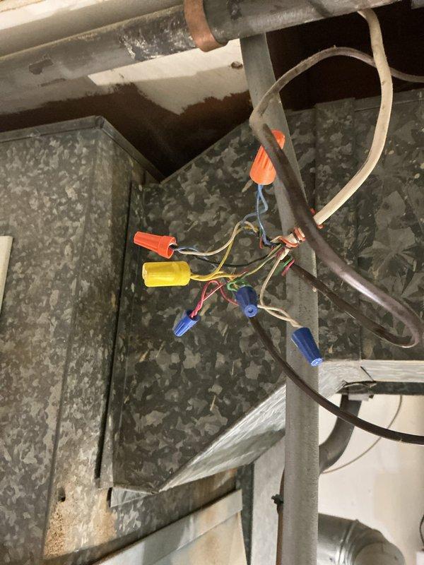 Responded to no cooling call on single HVAC unit located at back of house. Upon arrival, accessed attic space and inspected system components including ductwork, electrical connections, and wiring junctions. Examined thermostat wiring configuration, noting 5-wire setup with connections at G, W, Y, Rh, and Rc terminals. Verified proper wire terminations and RC-RH jumper wire installation per manufacturer specifications. Troubleshot system operation and restored cooling function. Unit tested and confirmed operational.