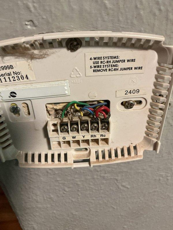 Responded to no cooling call on single HVAC unit located at back of house. Upon arrival, accessed attic space and inspected system components including ductwork, electrical connections, and wiring junctions. Examined thermostat wiring configuration, noting 5-wire setup with connections at G, W, Y, Rh, and Rc terminals. Verified proper wire terminations and RC-RH jumper wire installation per manufacturer specifications. Troubleshot system operation and restored cooling function. Unit tested and confirmed operational.