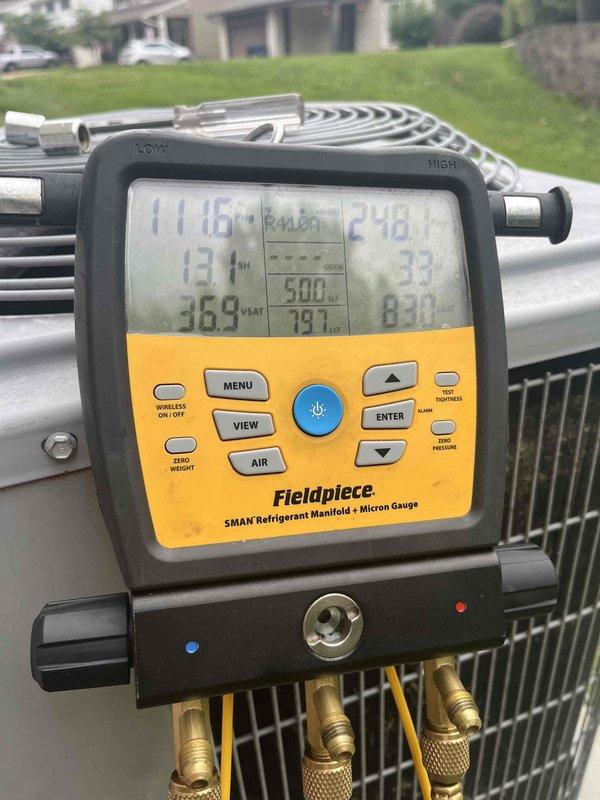 Responded to customer complaint of excessive humidity inside the home. Upon arrival, connected refrigerant manifold gauges to the 7-year-old ground-level condensing unit to assess system performance. Measured operating pressures and temperatures, which revealed abnormal readings indicating potential refrigerant charge issues or system inefficiency. Performed diagnostic testing using digital manifold to evaluate superheat and subcooling values. Documented system conditions with photos showing pressure readings of 112.5 PSI low side and 244.1 PSI high side during initial testing, followed by adjusted readings during heat mode operation. The elevated humidity complaint correlates with improper system operation affecting dehumidification capacity. Recommended further evaluation of refrigerant charge levels and potential system adjustments to restore proper cooling and dehumidification performance.