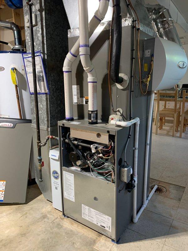 Completed comprehensive AC tune-up on 1-year-old residential unit located in basement. Performed full system inspection including checking refrigerant levels with digital manifold gauge, verifying electrical connections and controls within furnace cabinet, inspecting condensate drainage through PVC piping system, and testing overall system operation. All components found to be functioning properly with no deficiencies noted; unit operating within manufacturer specifications.