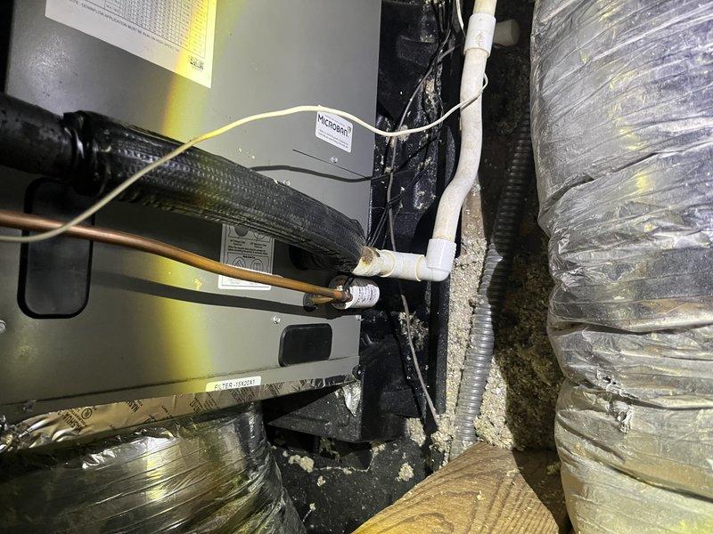 Responded to service call for non-operational air conditioning system with reported fan failure and potential thermostat malfunction. Accessed attic-mounted air handler unit via 12-foot ladder and performed diagnostic inspection of approximately 10-year-old system. Upon examination, identified issues with air handler operation and verified electrical connections, blower motor functionality, and thermostat communication. Inspected evaporator coil, condensate drain system, and ductwork connections for proper operation. Noted existing moisture staining on drain pan and general equipment condition consistent with system age. Restored system to operational status and verified proper airflow through supply ducts.
