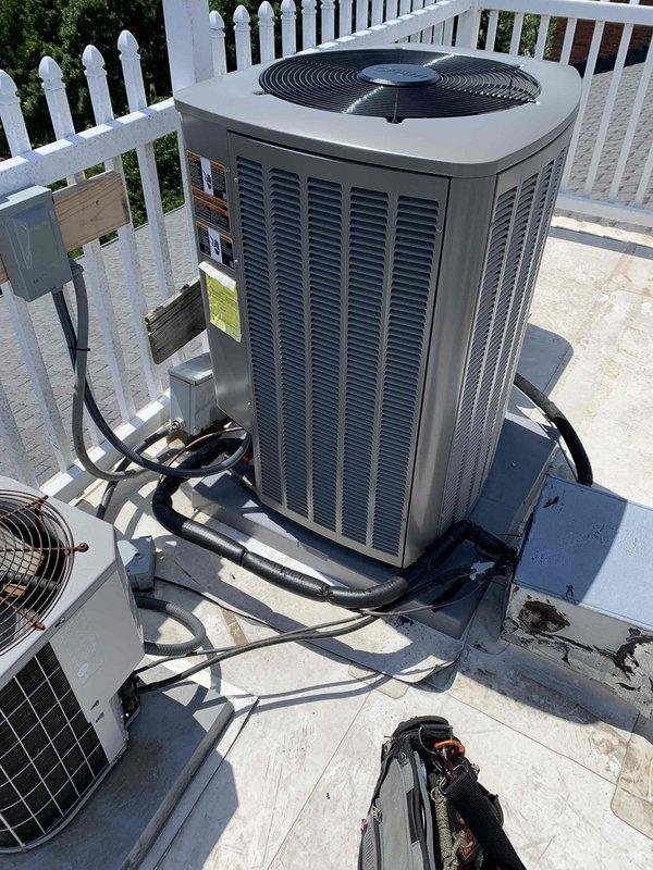 Responded to install callback for non-operational AC system displaying air handler fault and blower motor start fault error messages. Verified proper installation and operation of new S40 system including outdoor condensing unit, air handler with 9KW heat kit, new return base with 16x20 filter rack, drain pan, wet switch, electrical disconnect, and refrigerant line set. Cleared fault codes, confirmed system startup sequence, verified proper airflow and cooling operation, and documented completed installation with photos showing rooftop-mounted equipment properly secured with all components functioning as designed.