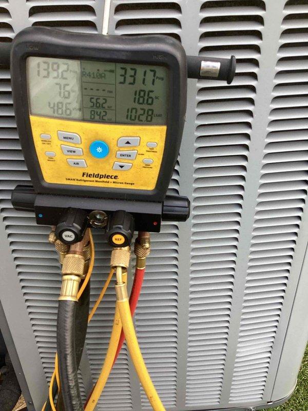 Responded to no-cool call for 10+ year old basement unit that customer reported as leaking and shut off. Upon arrival, connected digital manifold gauges to outdoor condensing unit and performed comprehensive system diagnostics, measuring refrigerant pressures and temperatures across multiple zones. Diagnostic readings revealed abnormal pressure differentials and temperature variances indicating potential refrigerant leak and/or system inefficiency. Conducted thorough visual inspection of condensing unit exterior, checking for signs of refrigerant oil residue, corrosion, or physical damage to cabinet and components. Documented system conditions with detailed photographs showing gauge readings and equipment status for service records and customer reference.