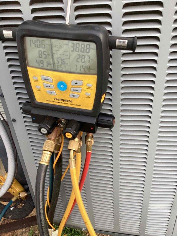 Responded to no-cool call for 10+ year old basement unit that customer reported as leaking and shut off. Upon arrival, connected digital manifold gauges to outdoor condensing unit and performed comprehensive system diagnostics, measuring refrigerant pressures and temperatures across multiple zones. Diagnostic readings revealed abnormal pressure differentials and temperature variances indicating potential refrigerant leak and/or system inefficiency. Conducted thorough visual inspection of condensing unit exterior, checking for signs of refrigerant oil residue, corrosion, or physical damage to cabinet and components. Documented system conditions with detailed photographs showing gauge readings and equipment status for service records and customer reference.