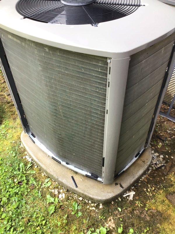 Completed comprehensive tune-up service on outdoor AC condenser unit. Performed thorough inspection of control board and electrical connections, verified proper wiring configuration and component operation. Cleaned condenser coils showing algae buildup on exterior fins, inspected fan assembly and top grille for proper operation, and confirmed unit is operating within normal parameters on concrete pad with adequate clearance.