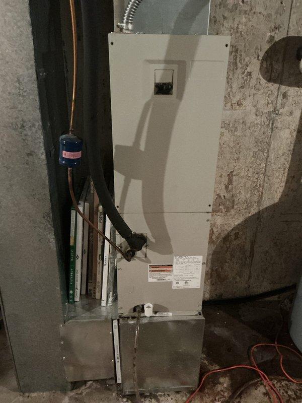 Responded to service call for cooling system issue on 15-year-old air conditioning unit. Upon arrival, performed comprehensive system diagnostic including inspection of air handler, refrigerant lines, and associated components. Evaluated indoor unit installation in mechanical room, checking refrigerant line connections, filter drier, and condensate drainage system for proper operation. Verified electrical connections and assessed overall system performance. Documented equipment condition with photographic records showing air handler cabinet, refrigerant piping with filter drier component, condensate pan placement, and PVC drainage lines. System assessed and customer advised of findings.