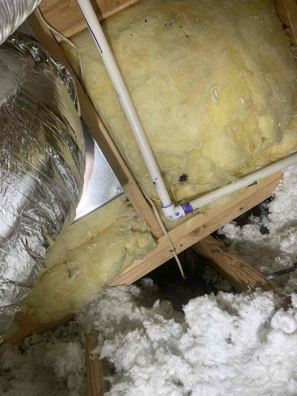 Completed drain line repairs in attic space for HVAC system experiencing no cooling issue. Installed approximately 8 feet of 3/4-inch PVC pipe with 45-degree elbow fitting and 10-12 feet of 5/8-inch vinyl tubing to restore proper condensate drainage. Used nitrogen to clear blockages and verify proper flow through repaired drain line system.