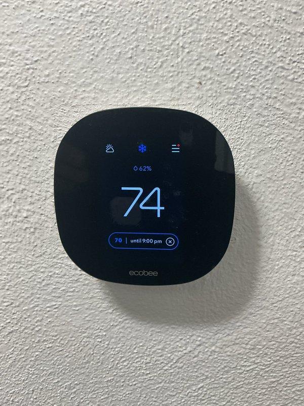 Completed preventive maintenance tune-up on a cooling system less than 10 years old located in the basement. Performed comprehensive inspection of all system components, including blower assembly which showed moderate dust and debris accumulation on the blower wheel and housing. Verified ecobee smart thermostat operation and confirmed proper temperature control and scheduling functions, with system maintaining 74°F setpoint and humidity reading at 62%. Inspected condensate drainage, electrical connections, refrigerant lines, and all safety controls to ensure proper system operation for the cooling season.