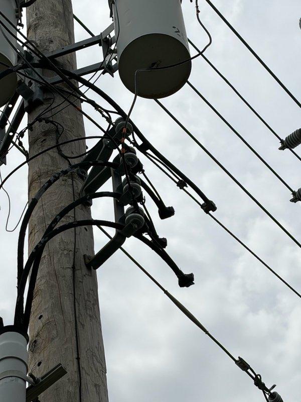 Responded to urgent no power complaint affecting multiple circuits throughout property. Upon arrival, identified utility-side issue at service pole with compromised transformer connections and deteriorated hardware causing low voltage conditions and complete power loss to certain areas. Documented existing conditions of utility infrastructure including pole-mounted transformers, service conductors, and connection points for utility company notification and repair coordination.