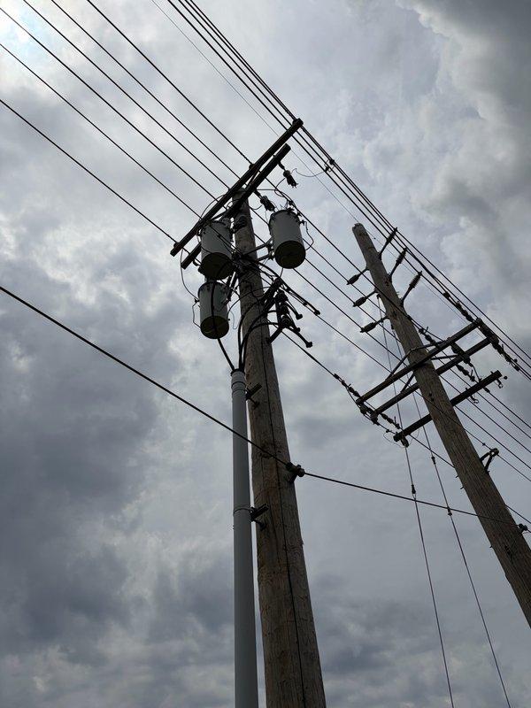 Responded to urgent no power complaint affecting multiple circuits throughout property. Upon arrival, identified utility-side issue at service pole with compromised transformer connections and deteriorated hardware causing low voltage conditions and complete power loss to certain areas. Documented existing conditions of utility infrastructure including pole-mounted transformers, service conductors, and connection points for utility company notification and repair coordination.