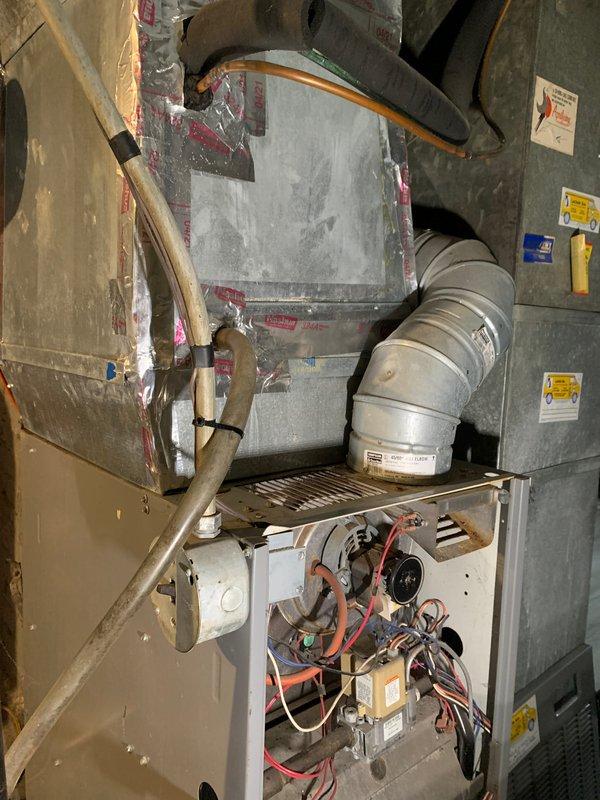 Completed comprehensive tune-up service on residential air conditioning system per Home Depot work order F58609720. Performed full system inspection of single outdoor condensing unit and indoor air handler/furnace assembly located in basement utility area. Evaluated blower motor assembly, electrical connections, and refrigerant line set with black insulation sleeves. Noted Filtrete air filters showing moderate dust accumulation at air handler intake. Verified all ductwork connections including white flexible ducting and metal supply plenum with reflective insulation. Confirmed proper operation of all HVAC components and documented system condition with photographs. Unit operational and ready for cooling season.