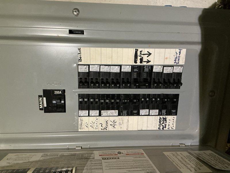Installed exterior motion-activated floodlight fixture on corrugated metal siding at building entryway to provide security illumination for driveway area. Ran electrical conduit along exterior wall surface, connected fixture to appropriate circuit at main electrical panel, and verified proper operation of motion sensor and lighting function upon completion.