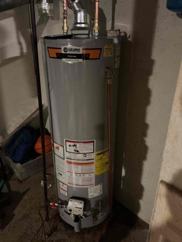Responded to no hot water complaint and completed full replacement of residential gas water heater in basement utility area. Removed existing failed unit and installed new 40-gallon gas tall water heater with proper venting and connections. Connected copper supply lines with brass fittings and valves, installed pressure relief valve with discharge piping, and ensured all gas connections were properly sealed and tested for leaks. Verified proper clearances around unit for safe operation and maintenance access. System tested and confirmed operational with adequate hot water delivery throughout residence.