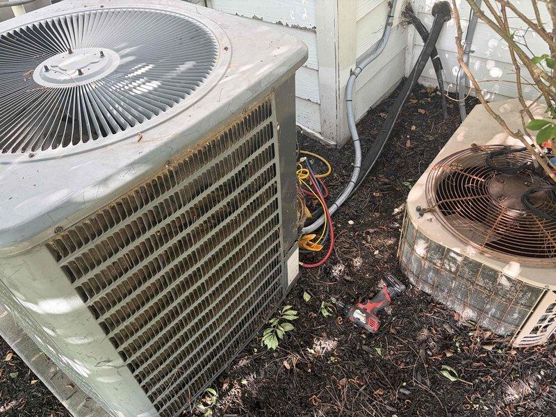 # Service Summary

Responded to no cooling complaint on 25-year-old ground-level AC unit. Upon arrival, found outdoor condenser with heavily clogged coil fins restricting airflow, preventing proper heat exchange and causing warm air discharge indoors.

# Work Performed

Performed diagnostic evaluation of condenser unit experiencing no cooling condition. Visual inspection revealed significant dirt, dust, and debris accumulation throughout heat exchanger coil fins, severely impacting system performance. The condenser showed signs of extended operation without routine maintenance, with environmental contamination blocking adequate airflow through the coil assembly.

Documented unit condition through photography showing extent of debris buildup on cooling fins and overall weathered state of 25-year-old equipment. Prior to service arrival, instructed occupant to power off AC unit while maintaining fan operation to prevent compressor damage and provide air circulation.

Assessed secondary co