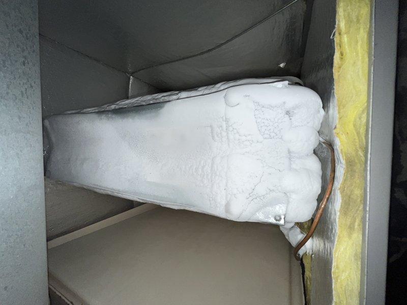 # HVAC Repair - No Cooling

Responded to service call for 12-year-old Lennox system with no cooling complaint. Upon inspection, discovered evaporator coil completely frozen with heavy ice accumulation throughout the air handler cabinet. Found severely restricted airflow due to heavily loaded air filter (18x20x1) with significant dust and debris buildup. 

Diagnosed frozen coil condition caused by restricted airflow from clogged filter, preventing proper heat exchange and causing refrigerant temperatures to drop below freezing point. Replaced dirty air filter with new unit. Allowed system to thaw completely before restoring operation. Verified proper airflow and cooling performance upon restart. Advised customer on importance of regular filter maintenance to prevent future freezing issues and ensure efficient system operation.