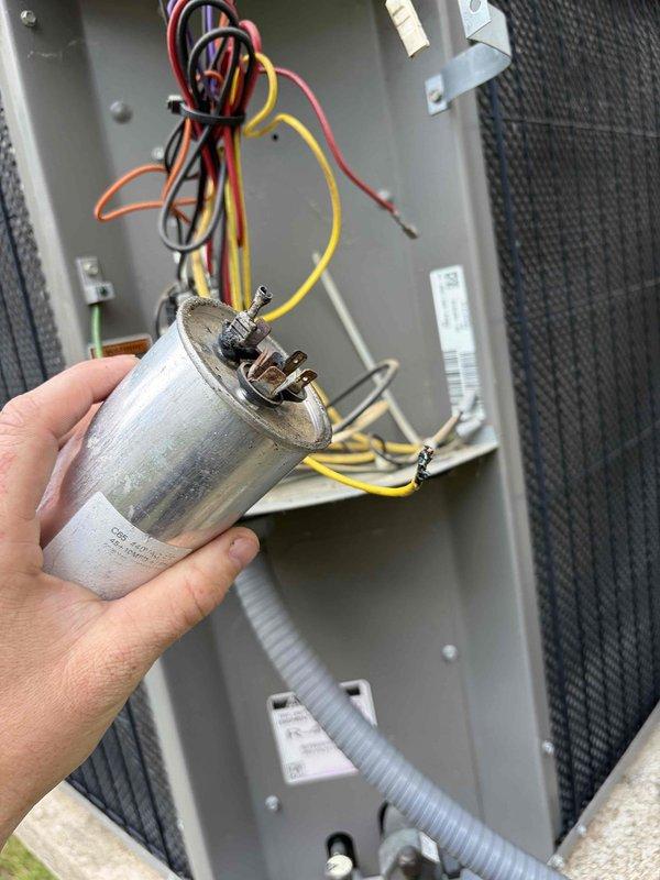Responded to no cooling complaint on 16-year-old Lennox system where customer reported hearing a loud bang the previous night. Upon inspection, found failed dual-run capacitor with visible damage. Verified amperage readings using clamp meter and replaced defective capacitor with new PROTECH unit, restoring proper operation to both compressor and condenser fan motor.