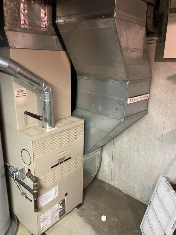 Conducted comprehensive indoor air quality evaluation of 15-year-old HVAC system to address persistent dust accumulation and odor issues in the home. Inspected Lennox furnace unit, supply and return ductwork, and air filtration components in basement mechanical room to identify sources of contamination and inadequate air filtration. Documented existing system configuration with photos and provided recommendations for IAQ improvement solutions including enhanced filtration options, possible air purification systems, and duct sealing to resolve ongoing air quality concerns.