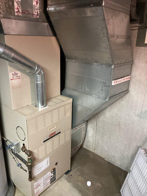 Conducted comprehensive indoor air quality evaluation of 15-year-old HVAC system to address persistent dust accumulation and odor issues in the home. Inspected Lennox furnace unit, supply and return ductwork, and air filtration components in basement mechanical room to identify sources of contamination and inadequate air filtration. Documented existing system configuration with photos and provided recommendations for IAQ improvement solutions including enhanced filtration options, possible air purification systems, and duct sealing to resolve ongoing air quality concerns.
