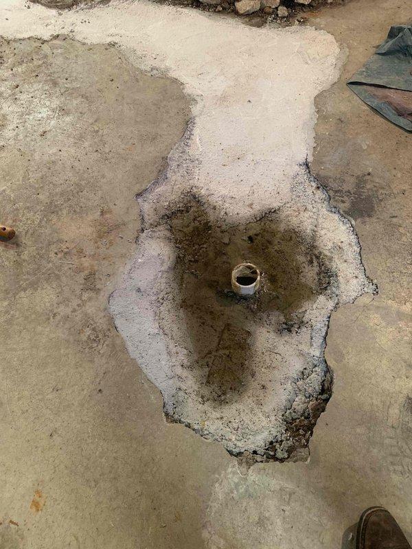 Responded to basement drain backup issue where line had previously been repaired. Performed mechanical snaking of the drain line to clear obstruction, then conducted video camera inspection to assess interior condition of the pipe and identify any underlying issues. Documentation photos show basement floor area with visible water staining around floor drain and evidence of recent moisture intrusion, confirming the reported backup condition prior to service intervention.