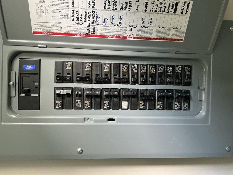 Conducted comprehensive site evaluation for electric vehicle charging station installation and recessed lighting addition. Assessed existing electrical panel capacity and available breaker spaces to determine infrastructure requirements for EV charger circuit. Documented current panel configuration showing dual-row breaker arrangement with main disconnect and digital monitoring display. Evaluated ventilation pathway and ceiling cavity access for proposed recessed lighting installation locations. Provided detailed estimate for materials and labor required to install dedicated EV charging circuit with appropriate amperage rating and recessed can light fixtures with associated wiring and controls.