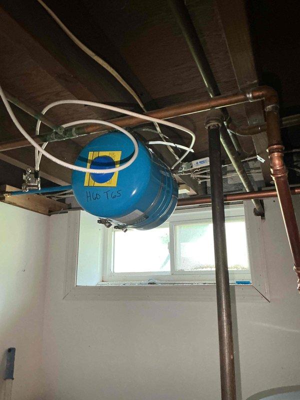 Installed 40-gallon gas tall water heater in basement utility area under permit #26PLU-12794. Installation included 3/4" high-pressure reducing valve (PRV) to regulate incoming water pressure and 3/4" ProPress ball valve for water supply isolation. All copper piping connections completed with brass fittings, PRV properly configured to protect new water heater from excessive line pressure. Unit secured and vented according to code specifications, all connections pressure tested and verified operational.