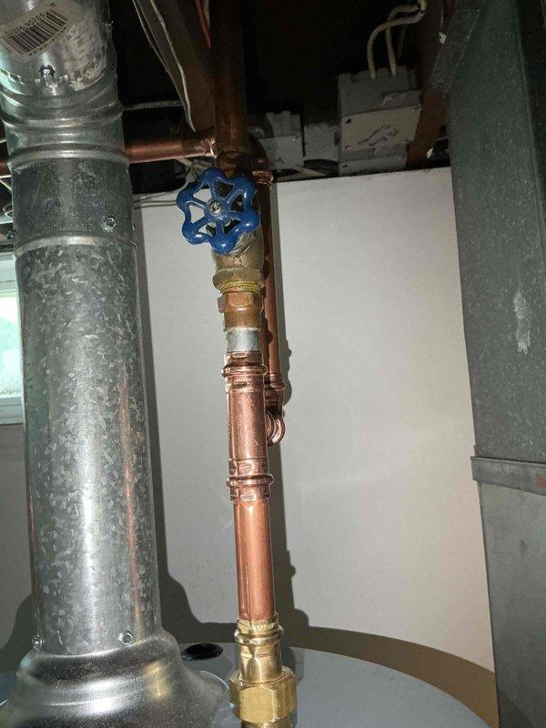 Installed 40-gallon gas tall water heater in basement utility area under permit #26PLU-12794. Installation included 3/4" high-pressure reducing valve (PRV) to regulate incoming water pressure and 3/4" ProPress ball valve for water supply isolation. All copper piping connections completed with brass fittings, PRV properly configured to protect new water heater from excessive line pressure. Unit secured and vented according to code specifications, all connections pressure tested and verified operational.